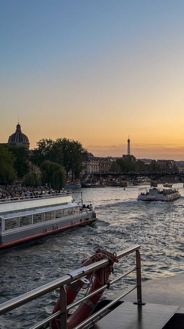 Bateau-mouche naviguant sur la Seine à Paris avec vue sur les monuments emblématiques et les quais de la capitale.